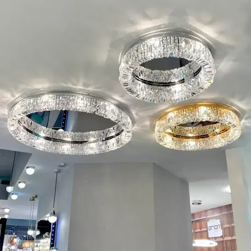 Three modern chrome and gold decorbites crystal ceiling lamps with double-ring clear crystal design for luxe living rooms