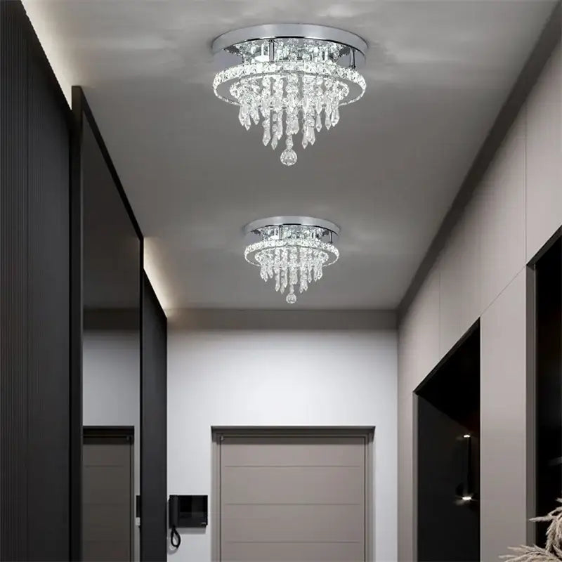 Two identical decorbites crystal ceiling lamps feature chrome bases and cascading clear glass prisms with smart LED control