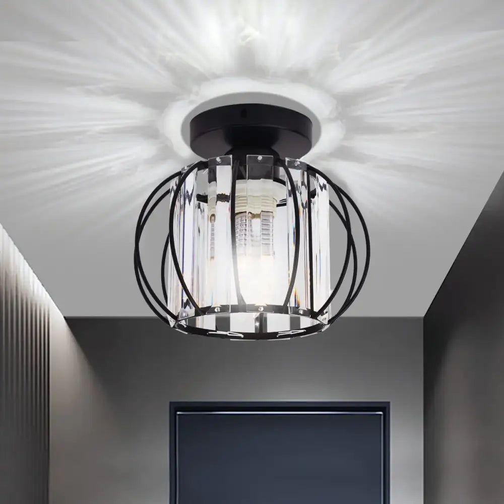 Black metal cage decorbites crystal ceiling light fixture with clear crystal accents and warm diffused glow