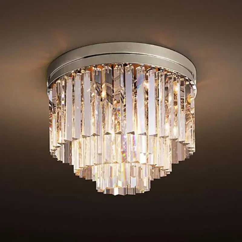 A modern decorbites crystal ceiling light with a sleek chrome base and cascading clear faceted glass prisms
