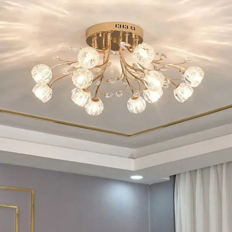 Gold-toned decorbites crystal ceiling light with crystal bulbs and branch-style arms by Samsarah Lighting for luxury spaces