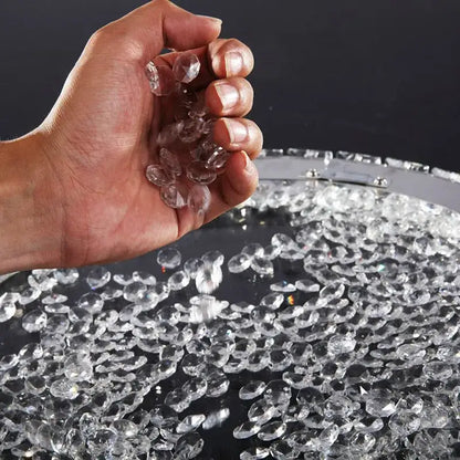 Hand holding clear faceted crystal beads from decorbites crystal ceiling light with LED bulbs for living room use