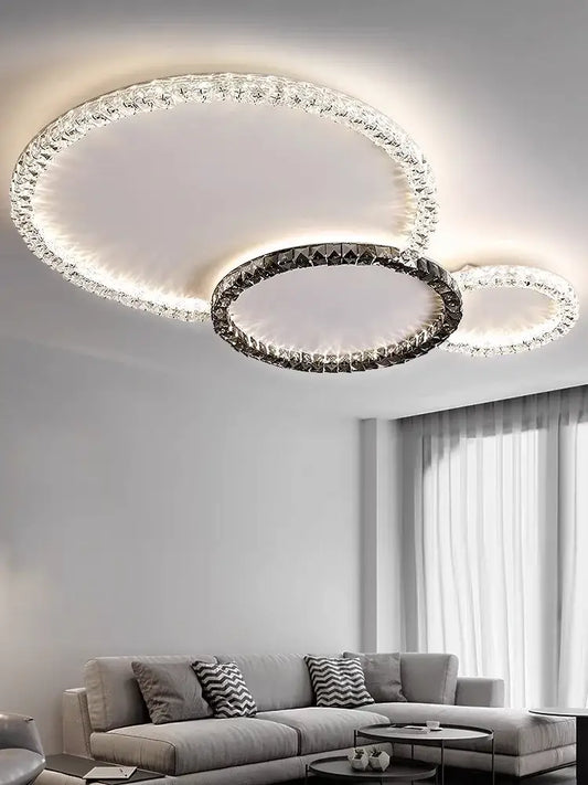 Modern decorbites crystal ceiling light with three interlocking rings featuring clear crystals and sleek metallic frame for living room