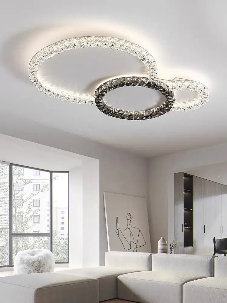 Modern decorbites crystal ceiling led chandelier with three interlocking rings and clear dark faceted crystals in metallic frame