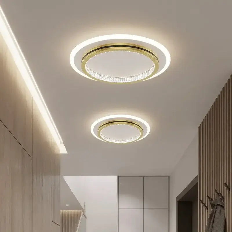 Modern decorbites crystal ceiling lights with gold-toned frame, illuminated inner ring, and decorative crystal accents
