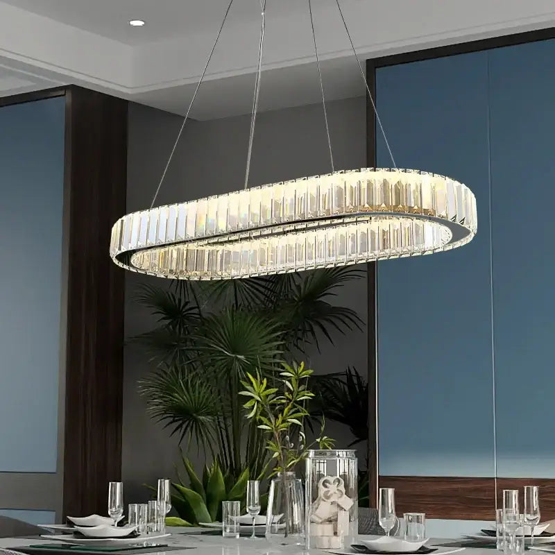 Modern decorbites crystal ceiling pendant chandelier with clear crystal prisms and sleek metallic frame for luxe decor