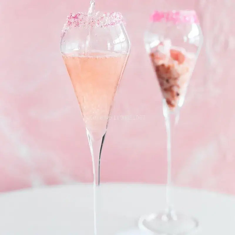 A decorbites crystal champagne flute filled with pink bubbly liquid rimmed with sparkling sugar for celebrations