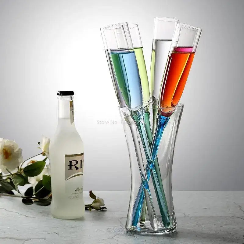 Clear glass decorbites crystal champagne wine glasses with colorful liquids in a twisted transparent vase for parties
