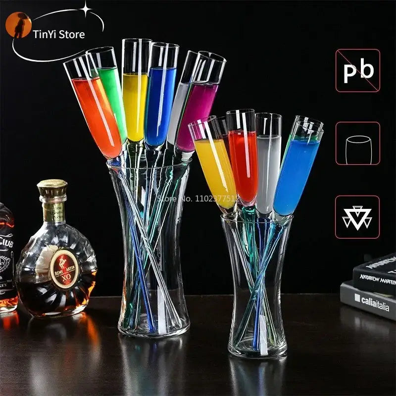 Set of colorful decorbites crystal champagne wine glasses filled with vibrant liquids arranged in clear glass vases