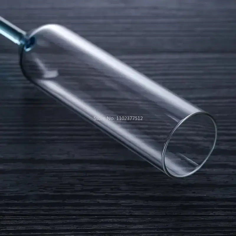 Clear glass cylindrical container with narrow neck featuring decorbites crystal champagne wine glass design