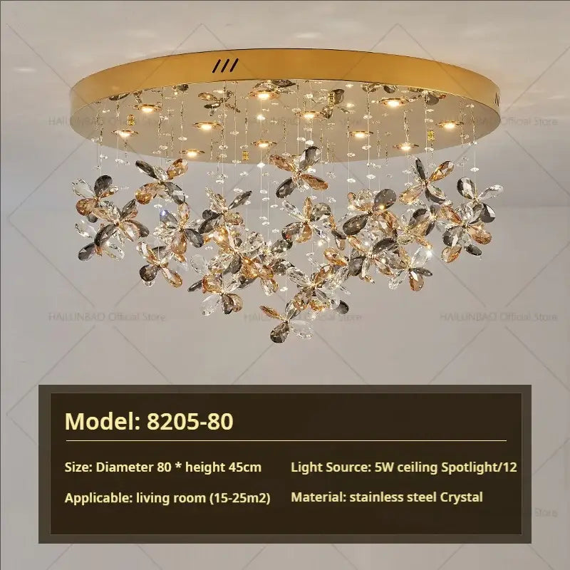Gold-toned decorbites crystal chandelier with dangling clear and amber crystal flower clusters in stainless steel frame