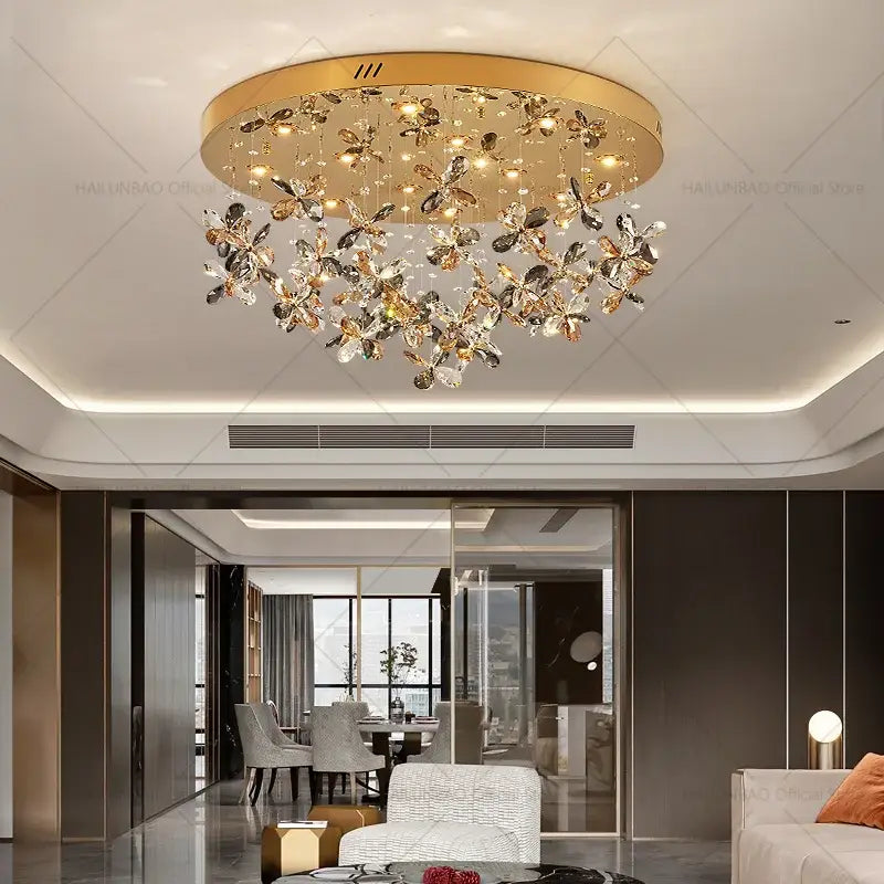 Gold-toned decorbites crystal chandelier with dangling crystal butterfly motifs for luxury dining room lighting