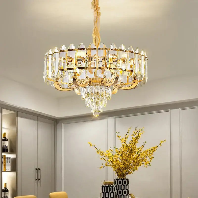 Gold-toned decorbites crystal chandelier with clear crystal prisms and dangling crystals for living and dining rooms