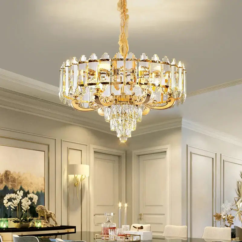 Gold-toned decorbites crystal chandelier with clear crystal prisms and dangling crystals for living room lighting