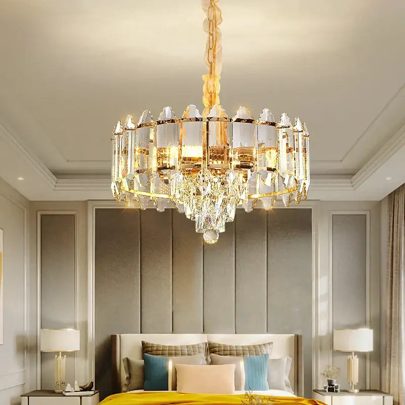 Gold-toned decorbites crystal chandelier with clear crystal prisms and matching chain for living room and bedroom lighting