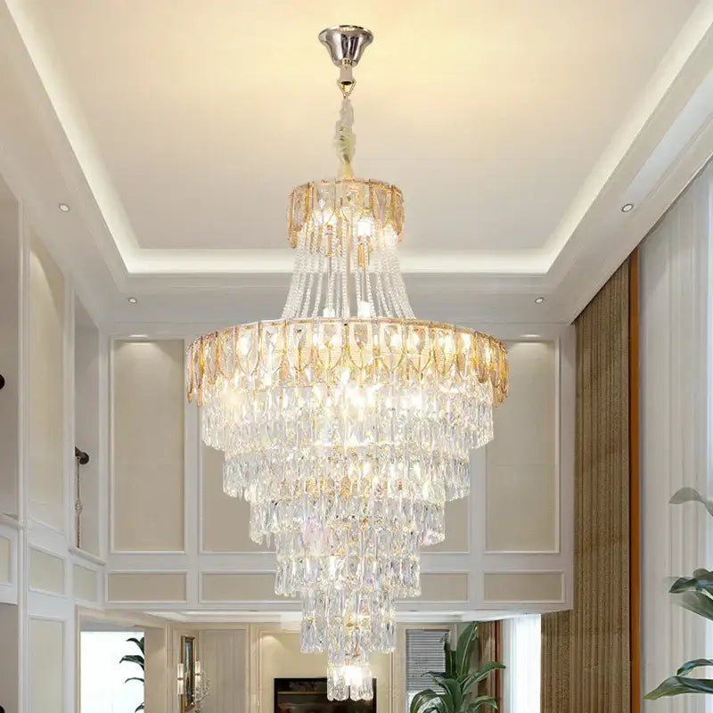 A decorbites crystal chandelier featuring cascading clear faceted crystals and gold-toned metal for elegant lighting