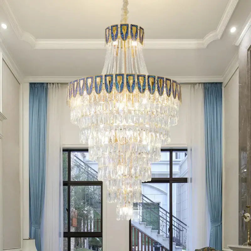 A multi-tiered DecorBites crystal chandelier with blue and gold accents featuring crystal chandelier art for elegant lighting