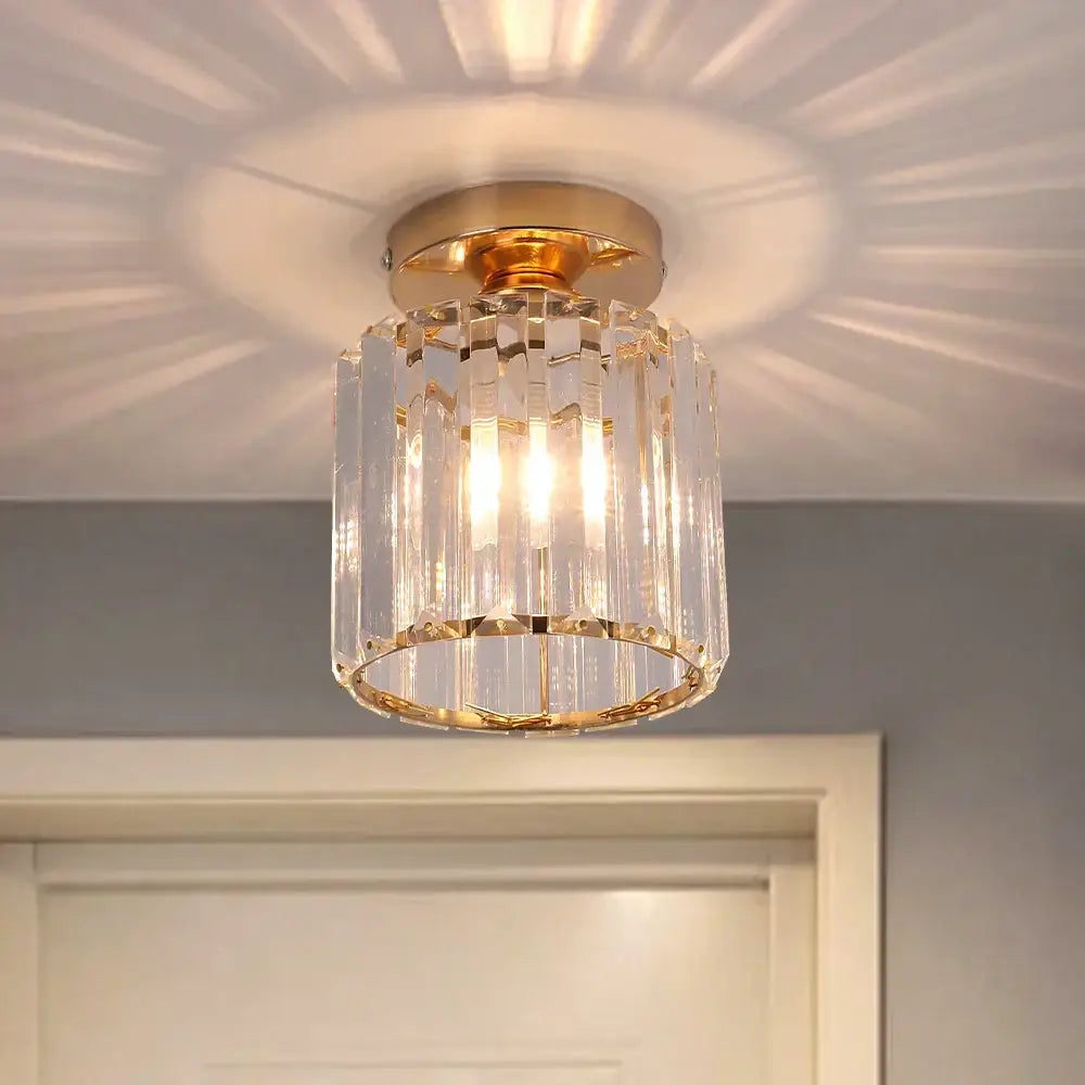 A gold-toned decorbites crystal chandelier ceiling light with clear faceted prisms for modern living room decor