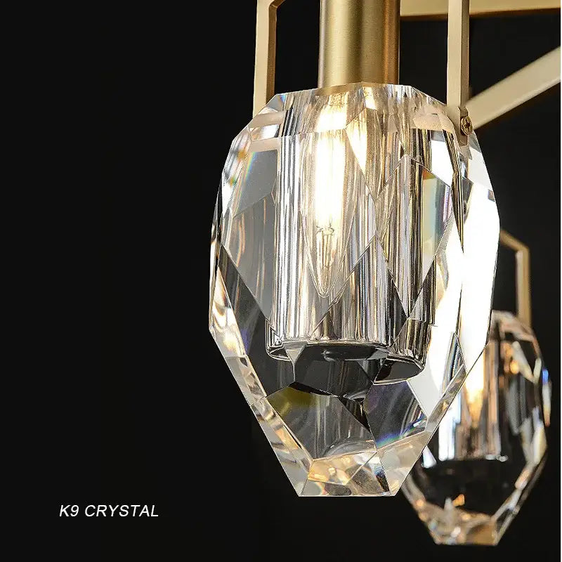 Decorbites crystal chandelier featuring a faceted clear k9 crystal pendant with a gold-toned frame chandelier ceiling light