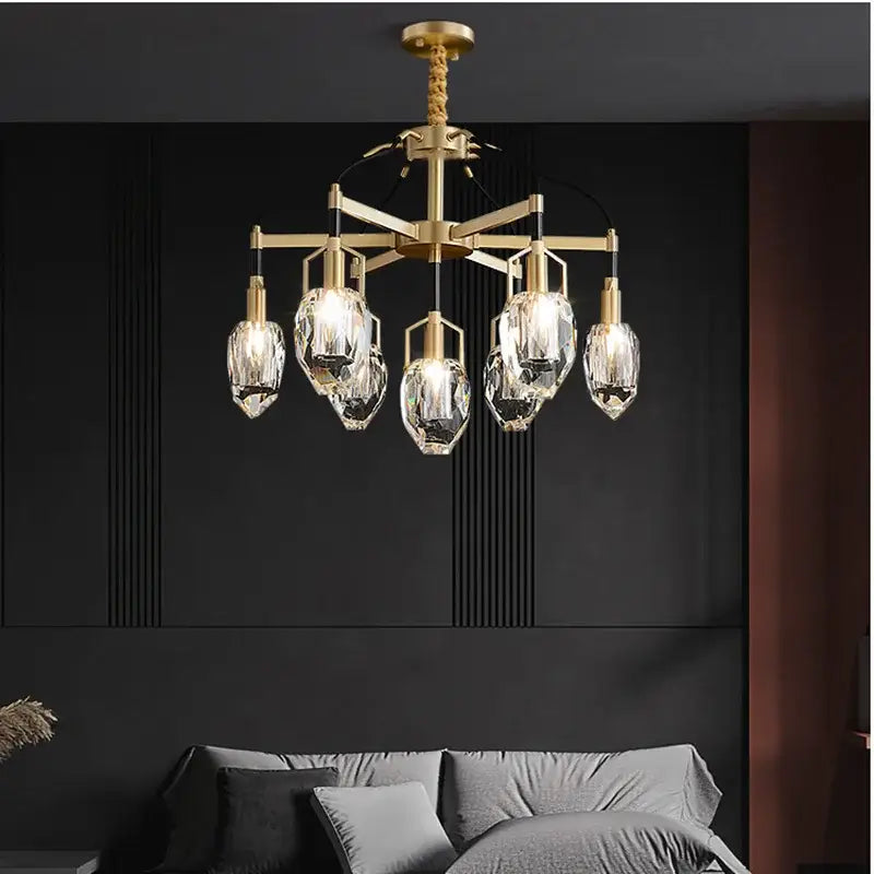 Gold-toned decorbites crystal chandelier ceiling light with five faceted crystal pendants on geometric brass frame
