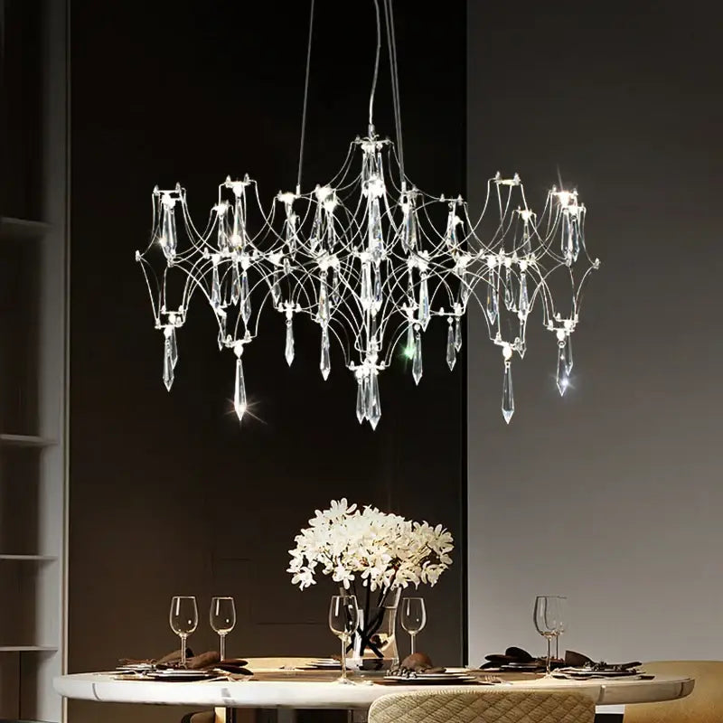 A modern decorbites crystal chandelier pendant light with multi slender metallic arms and clear crystal droplets