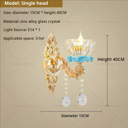 Gold-toned ornate decorbites crystal chandelier wall sconce with clear glass shade, blue ceramic, and white crystal pendants