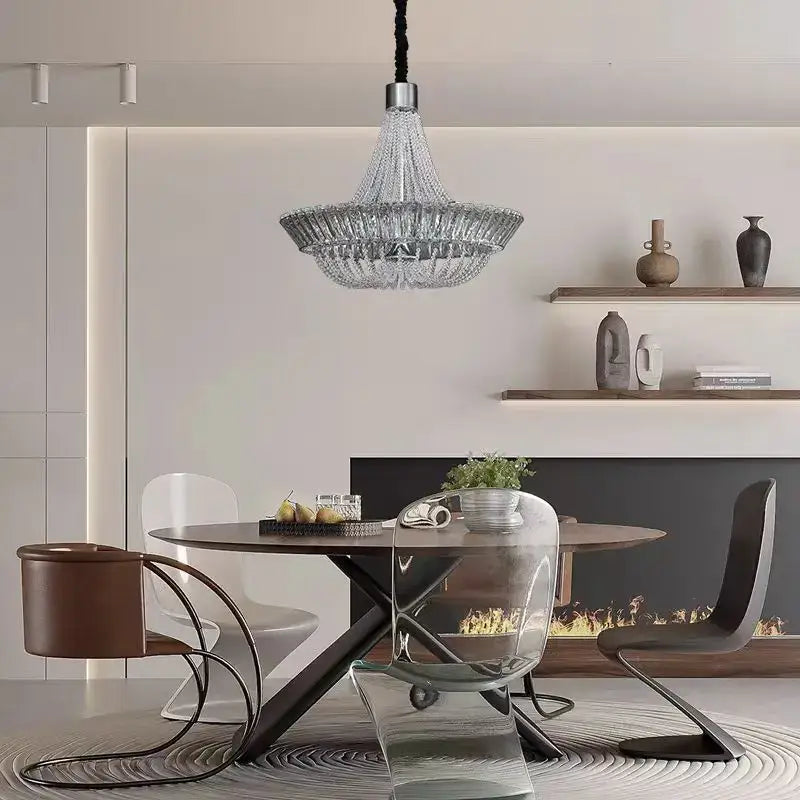 A modern decorbites crystal chandelier with sleek tiered chrome and gold design and hanging black cord for elegant lighting