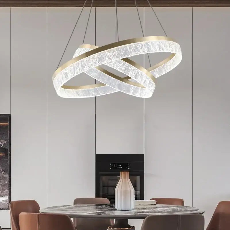 Modern gold-toned decorbites crystal chandelier pendant light with textured translucent crystal circular rings for dining decor