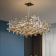 A decorbites crystal chandelier featuring clear and gold-toned crystal prisms in a modern square geometric design