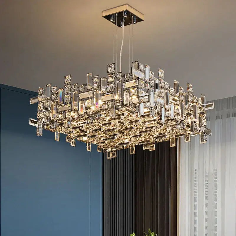 A decorbites crystal chandelier featuring clear and gold-toned crystal prisms in a modern square geometric design