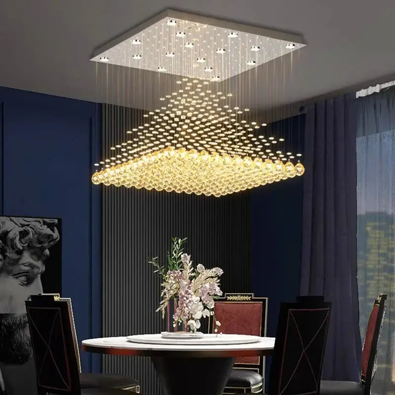 A decorbites crystal chandelier with cascading golden crystal beads and a sleek white frame for indoor ceiling use