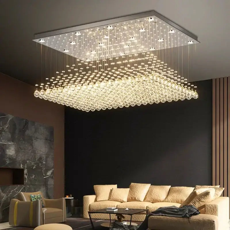 A decorbites crystal chandelier with a sleek metallic frame and cascading clear crystal droplets for dining room use