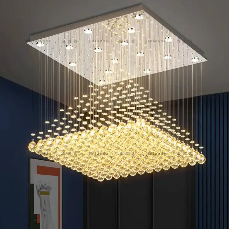 A decorbites crystal chandelier featuring a sleek metallic frame with cascading crystal beads and a golden glow for dining rooms