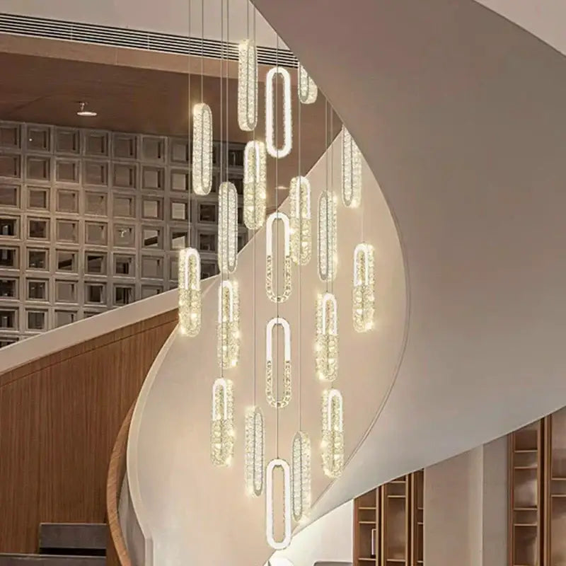 A modern decorbites crystal chandelier dining pendant light with illuminated crystal-encrusted oval and rectangular pendants