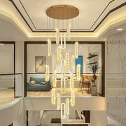 A decorbites crystal chandelier dining pendant light with gold ceiling mount and glowing cylindrical glass elements