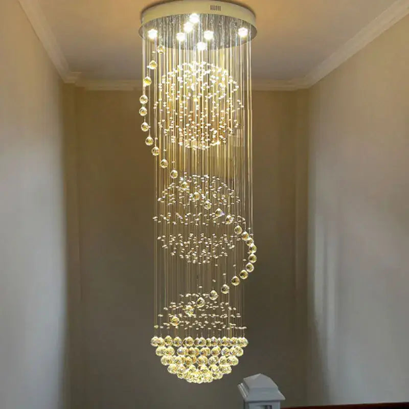 A modern decorbites crystal chandelier with cascading clear glass beads and circular ceiling mount for hotel and villa halls