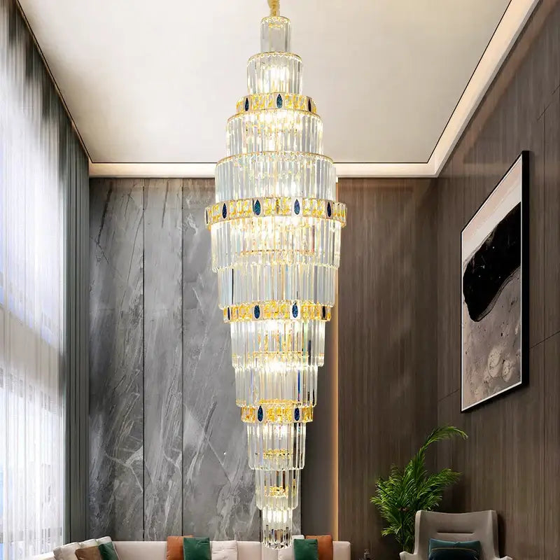 DecorBites crystal chandelier features a tall tiered design with gold accents and blue gemstone details for luxury lighting