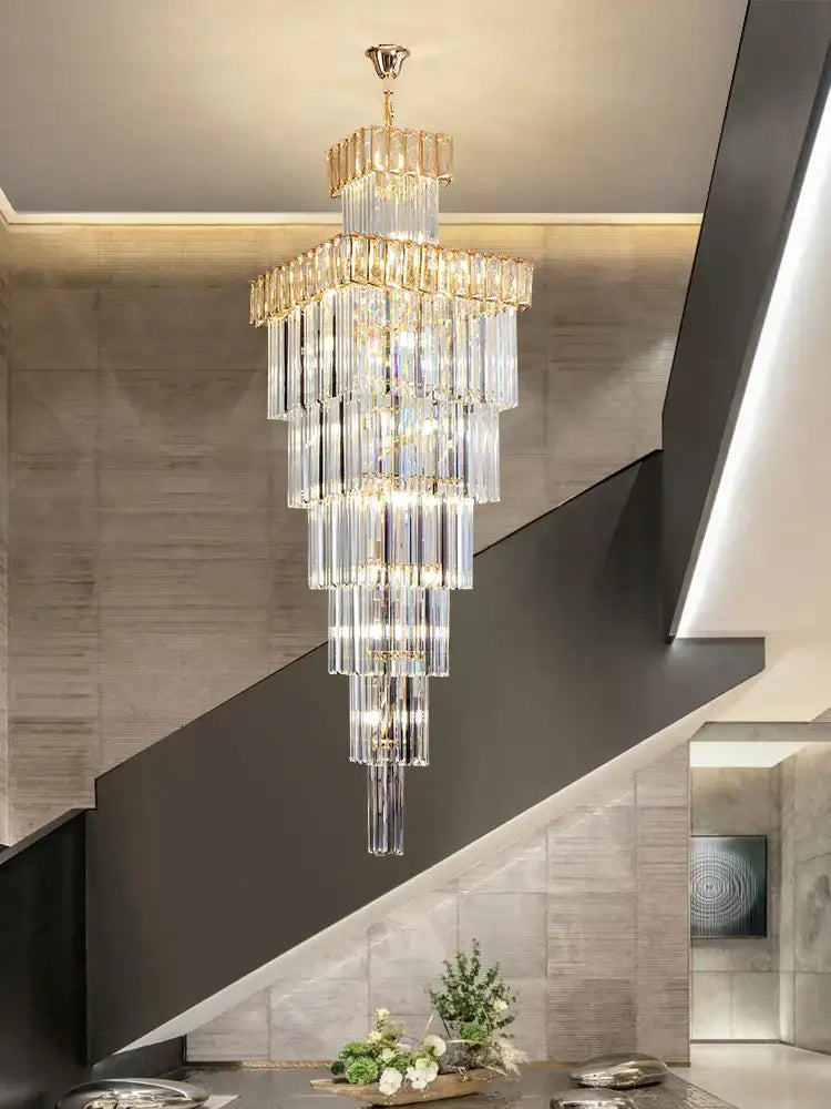 DecorBites crystal chandelier with multi-tiered crystals and gold-toned metal for duplex villa spiral staircase