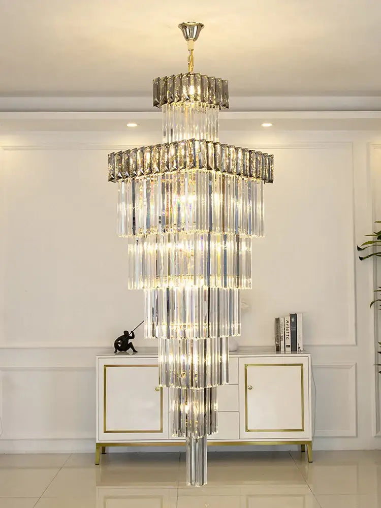 A decorbites crystal chandelier with cascading clear glass rods and gold-toned metal for duplex villa staircases