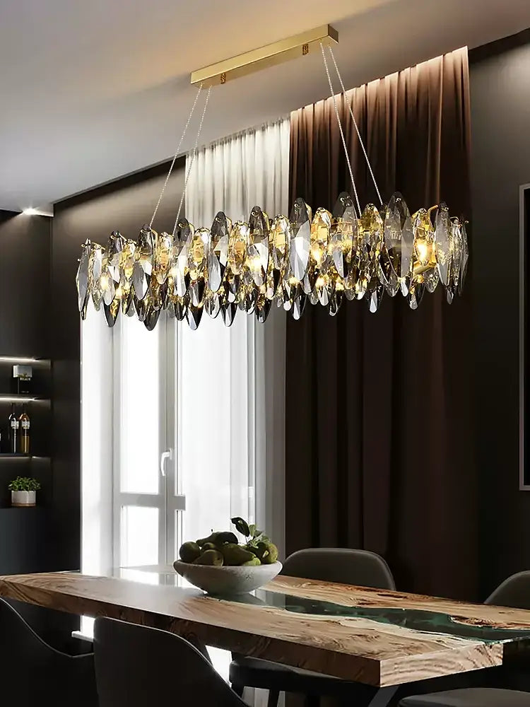 A modern decorbites crystal chandelier with gold metal frame and cascading clear amber crystals for living room lighting