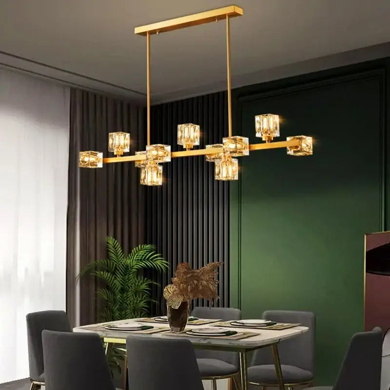 Gold-toned decorbites crystal chandelier with cube-shaped crystal lights suspended from a rectangular frame for living room
