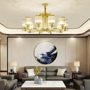 Gold-toned decorbites crystal chandelier with clear glass shades and geometric design for elegant living spaces