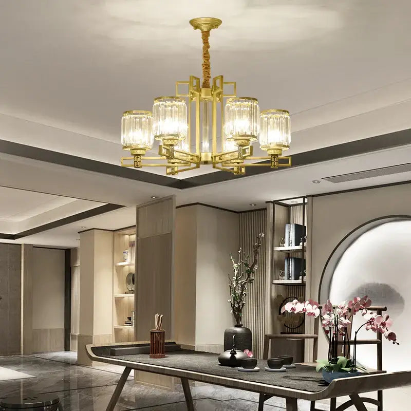 Gold-toned decorbites crystal chandelier with five glass shades and a modern geometric frame for living room lighting