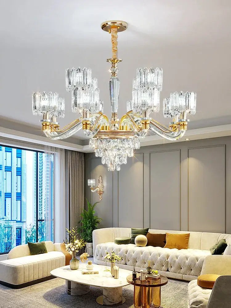A luxurious gold-toned decorbites crystal chandelier with multiple crystal arms and hanging crystals for living rooms
