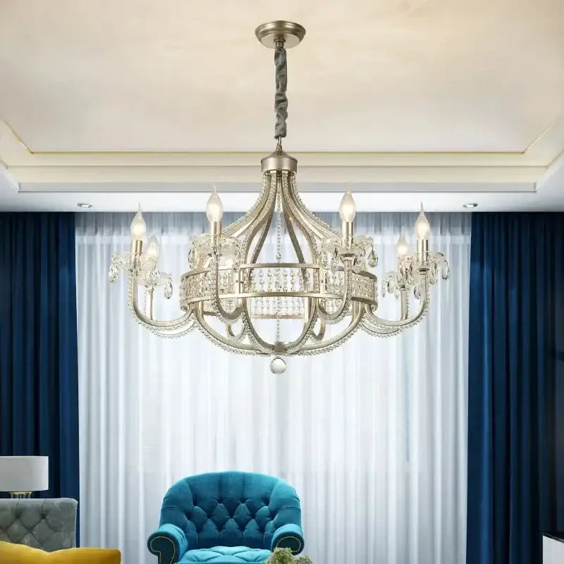 A silver-toned decorbites crystal chandelier with candle-style bulbs for living room dining room and bedroom use