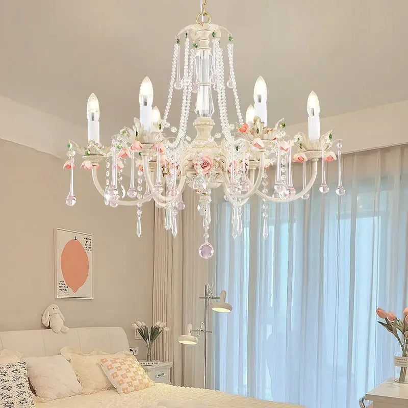 A delicate white DecorBites crystal chandelier with pink floral accents and crystal droplets for elegant rooms