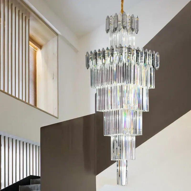 A decorbites crystal chandelier with multi-tiered cascading clear and frosted glass rods on a gold-toned chain