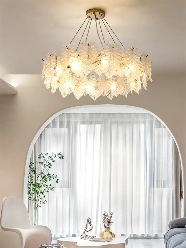 Decorbites crystal chandelier with translucent white leaf-shaped glass and gold-toned fixture for elegant living spaces