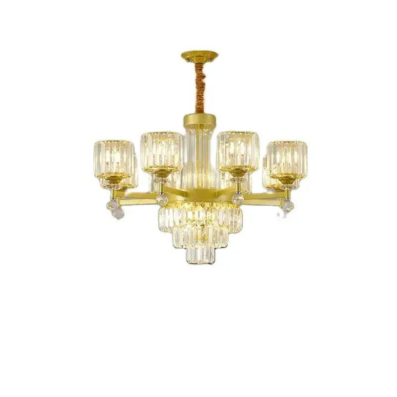 Gold-toned decorbites crystal chandelier with clear ribbed glass shades and cascading crystal droplets for luxury living rooms