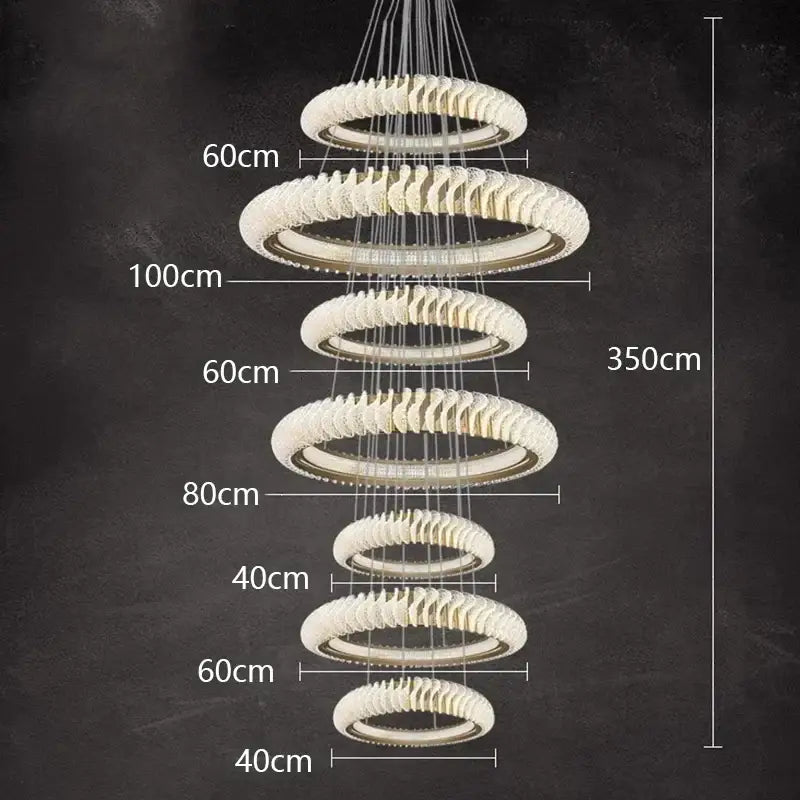 Modern multi-tiered decorbites crystal chandelier with frosted crystal rings and metallic accents for living and dining rooms